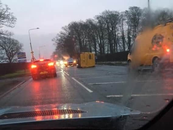 A yellow van has overturned after a collision in Catterall.