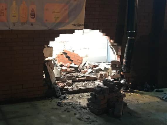 Bricks piled up after a car crashed into Morrisons at Bamber Bridge