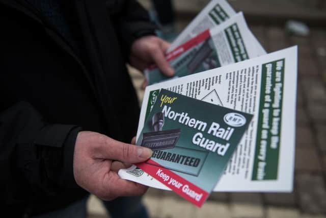 Members of rail staff taking industrial action hand out leaflets (Pic: OLI SCARFF/AFP/Getty Images)