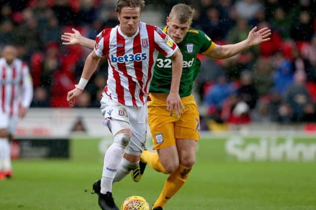 Preston striker Jayden Stockley tracks Stoke defender Moritz Bauer
