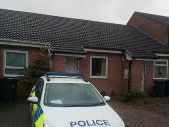 A police vehicle outside the house on Meadow Bank, Penwortham, this afternoon.