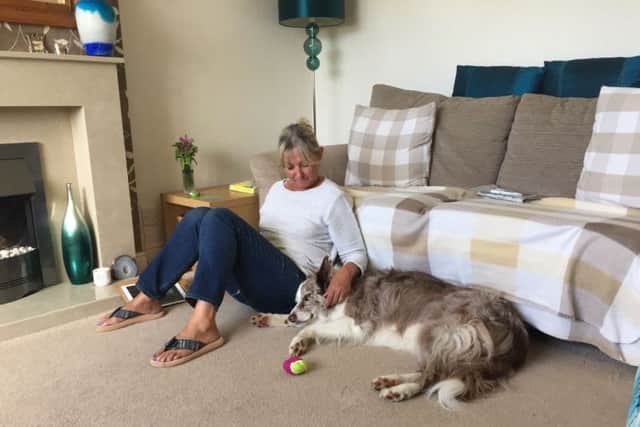 Lynda Elliott with one of the dogs at her home.