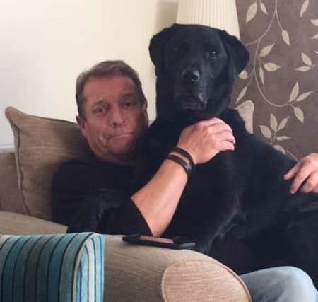 Dennis Elliott looking after a dog with Barking Mad
