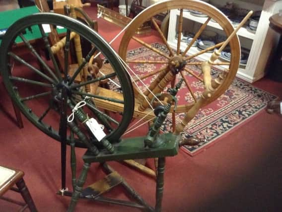 These spinning wheels are beautiful working examples