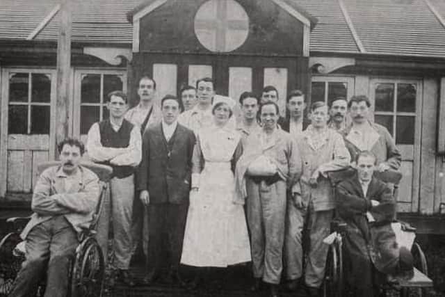 Nurses and injured soldiers pose for the camera at Moor Park Hospital