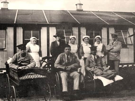 Nurses and injured soldiers pose for the camera at Moor Park Hospital