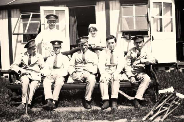Wounded soldiers pose with one of the nurses at Moor Park Hospital