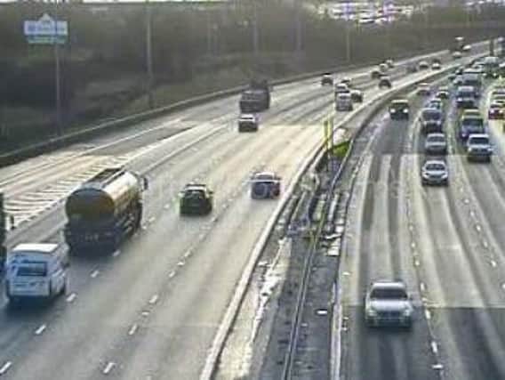 A broken down car is blocking a lane on the M6 between junctions 33 and 34 near Lancaster.