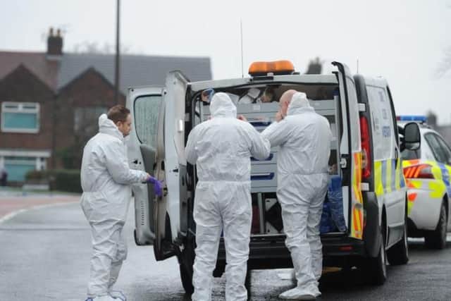 Forensics investigate the scene of the murder investigation in Moor Nook, Ribbleton.