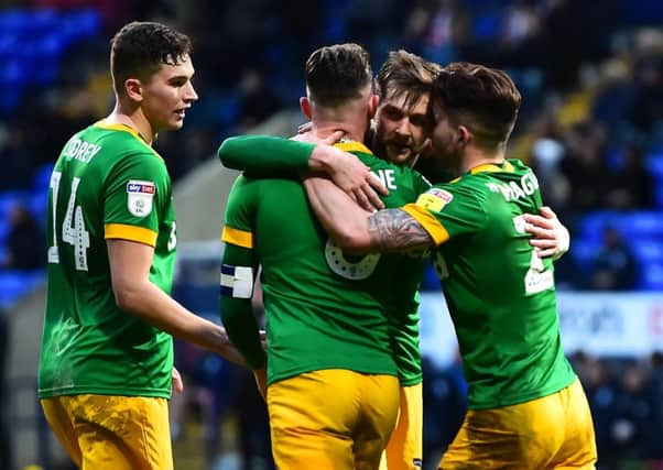 Tom Barkhuizen is congratulated by Jordan storey, Alan Browne and Sean Maguire after scoring the winning goal against Bolton