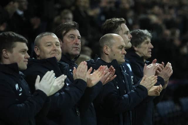 Alex Neil and the Preston backroom staff applaud the memory of Gordon Banks before kick-off