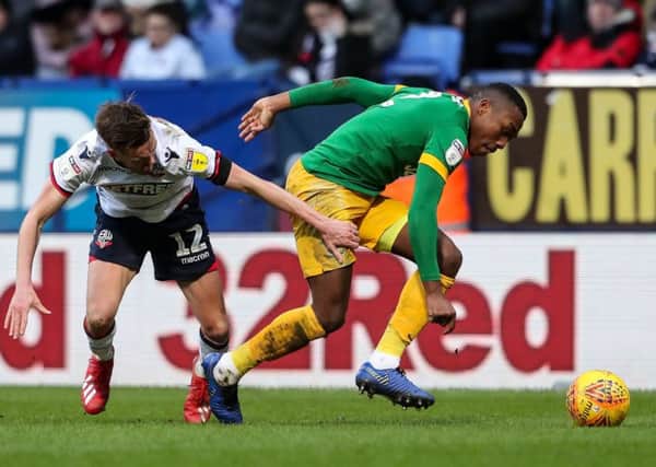 Darnell Fisher takes on Bolton winger Craig Noone
