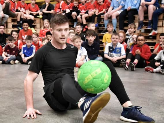John Farnworth shows his skills to young footballers