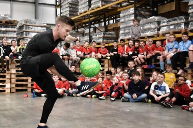 John Farnworth shows his skills to young footballers