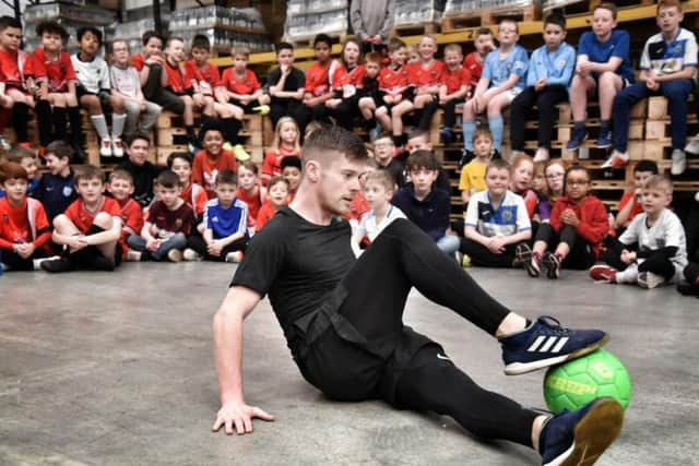 John Farnworth shows his skills to young footballers