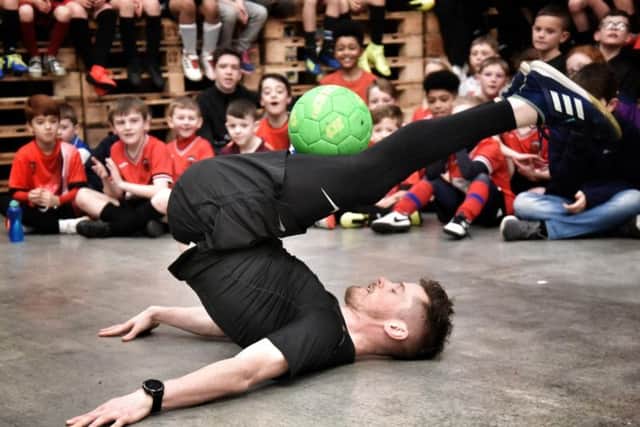 John Farnworth shows his skills to young footballers