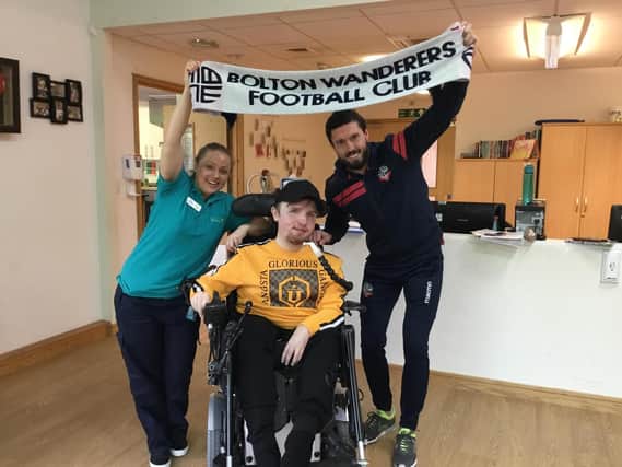 Derian House ambassador, Bolton Wanderers footballer Jason Lowe with charity member Claire Harding and service user Adam