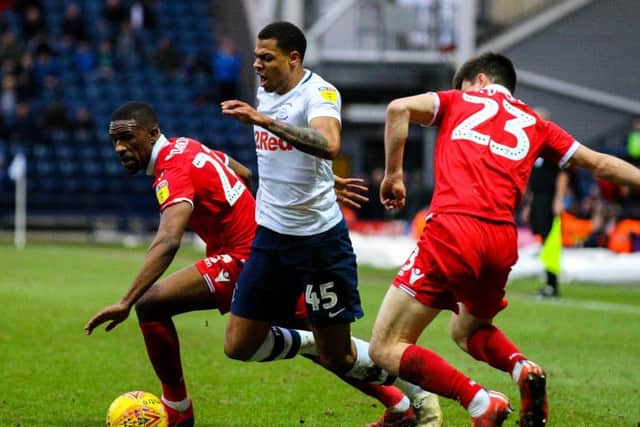Preston substitute Lukas Nmecha goes between two Nottingham Forest players at Deepdale