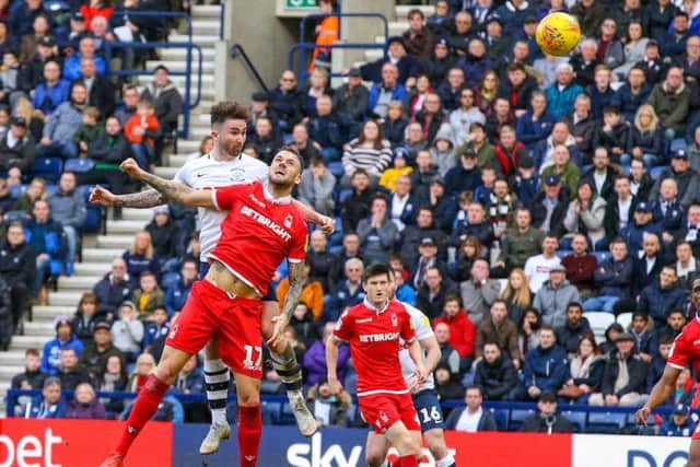 Sean Maguire battles with Alexander Milosevic at Deepdale on Saturday