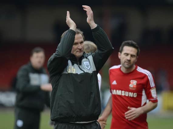 Simon Grayson salutes the PNE fans after his first game in charge of the Lilywhites