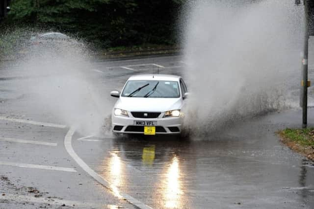 Cars going through flood water on the A59 at Penwortham