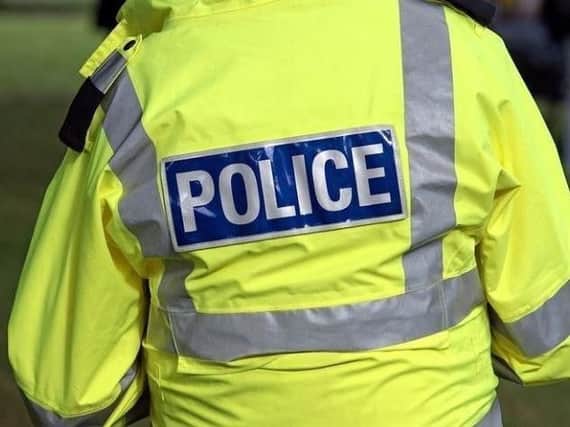 Police are hunting two men after a cyclist was pushed into a wall and suffered a serious head injury