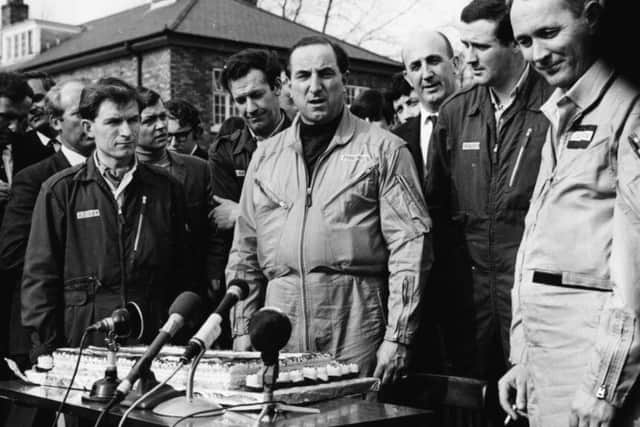 Test pilot Brian Trubshaw (centre), with his co-pilot John Cochrane (right) and his French counterpart Andre Turcat (behind, right), speaking at a press conference following his successful first flight of the Concorde 02 airliner, at RAF Filton, England, April 9, 1969. (Photo by George W. Hales/Fox Photos/Getty Images)