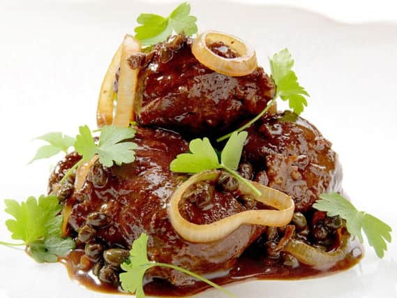 Braised pig cheeks, with capers and parsley