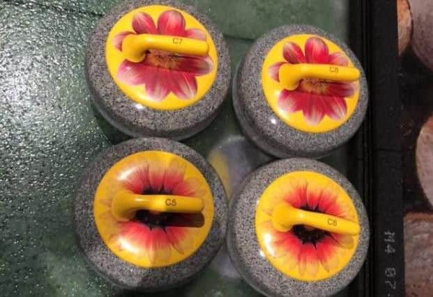 Flower-themed curling stones