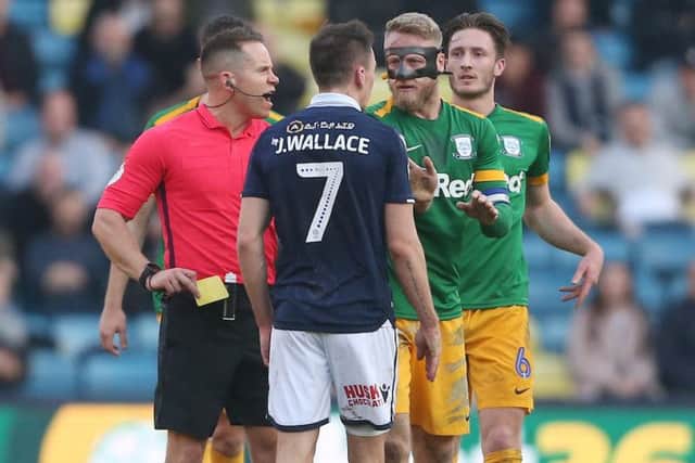 Referee Steve Martin comes between Jed Wallace and Tom Clarke