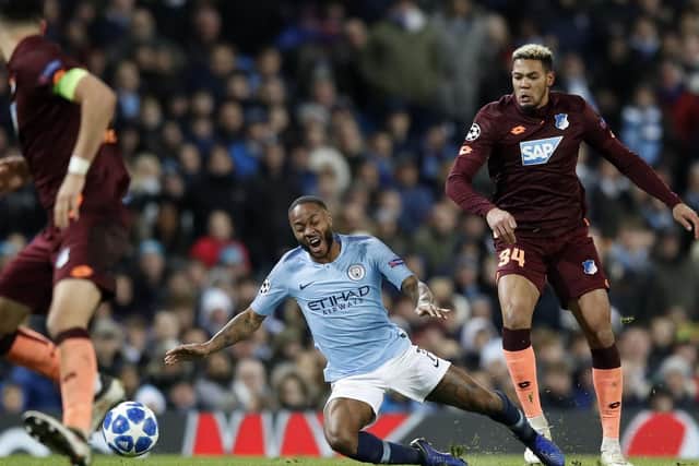 Manchester City's Raheem Sterling (centre) and Hoffenheim's de Lira Joelinton battle for the ball during the UEFA Champions League match at The Etihad Stadium