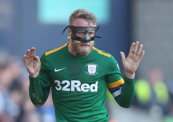 Masked skipper Tom Clarke in action in Preston's win at Millwall