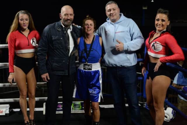 Cathy Dickinson (centre) in blue pictured at her boxing match with husband Micheal  and Russell Jarmesty  (photo: Grant Sullivan)