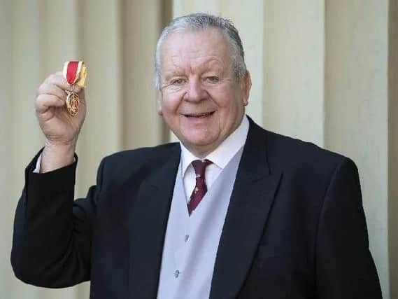 Bill Beaumont receiving his knighthood at Buckingham Palace