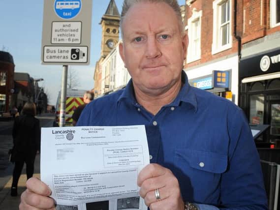 Stephen Parkinson beside the unclear sign