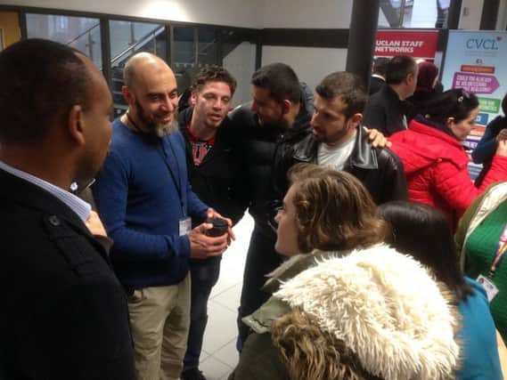 UCLan students talking to the refugees