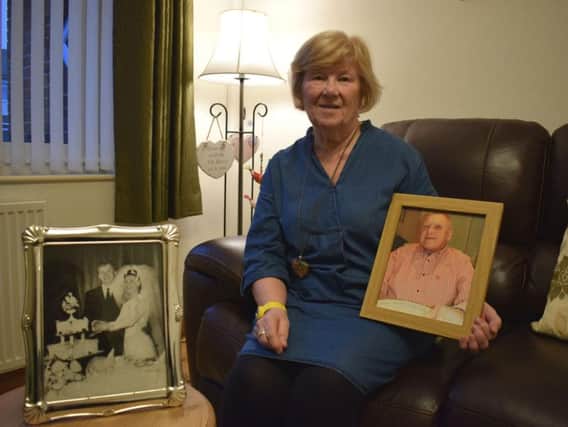 Margaret Hunt with photos of her husband, Gordon