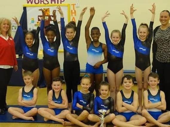 Kare Plus Care Manager Michelle Corcoran (left) and Deputy Manager Tanya Charles (right) with young gymnasts from St Joseph's Catholic Primary School with  in their new outfits