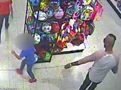 Image issued by West Mercia Police of the moment Adam Cech (bottom left) sprayed a three-year-old boy (blue T-shirt) with acid in an attack in a Home Bargains store in Worcester.
