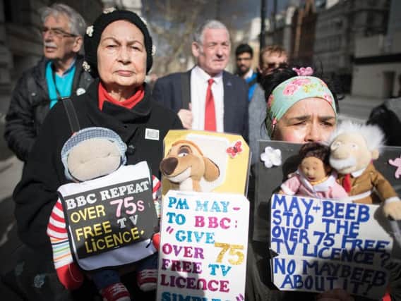 Members of the National Pensioners Convention (NPC) protest in Westminster at the government's decision to pass responsibility for funding the TV licence for over-75s onto the BBC.