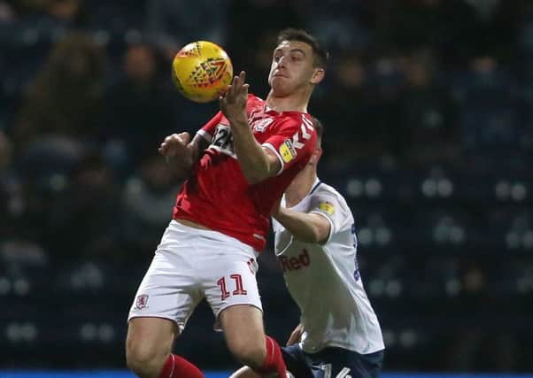 Middlesbrough's Jordan Hugill controls the ball under pressure from Preston North End's Jordan Storey