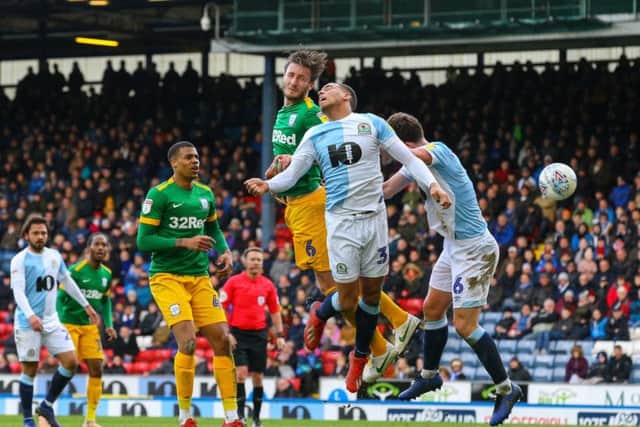 Preston's man of the match Ben Davies gets up high above Blackburn's attack