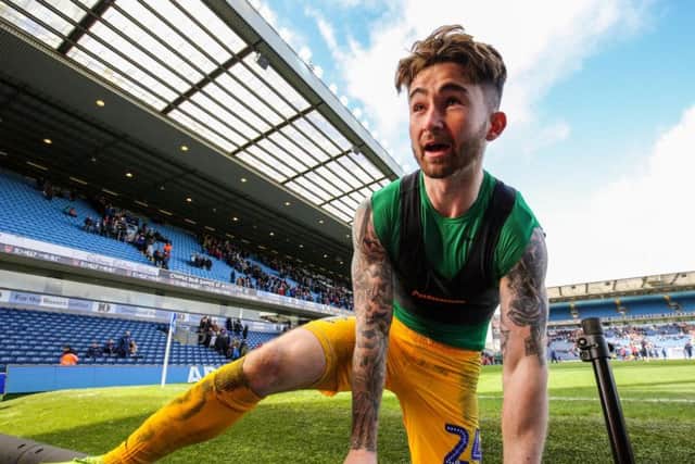 Preston striker Sean Maguire climbs the barrier to give a PNE fan his shirt at full-time
