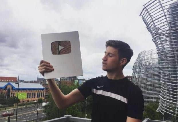 Liam with his YouTube plaque for 100,000 subs.