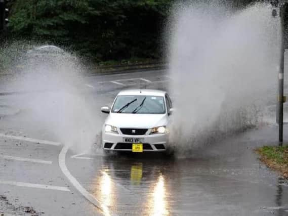 Cars going through flood water on the A59 at Penwortham.