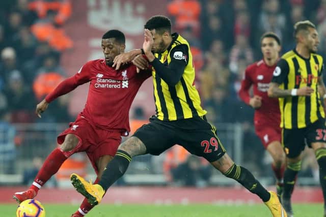 Liverpool's Georginio Wijnaldum and Watford's Etienne Capoue battle for the ball during the Premier League match at Anfield