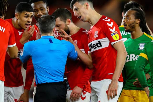 Middlesbrough players protest to referee Keith Stroud after Daniel Ayala's red card