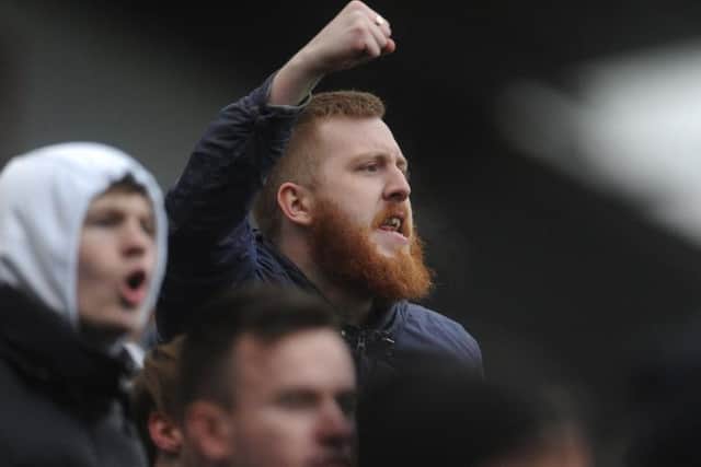 A North End fan celebrates victory at the final whistle