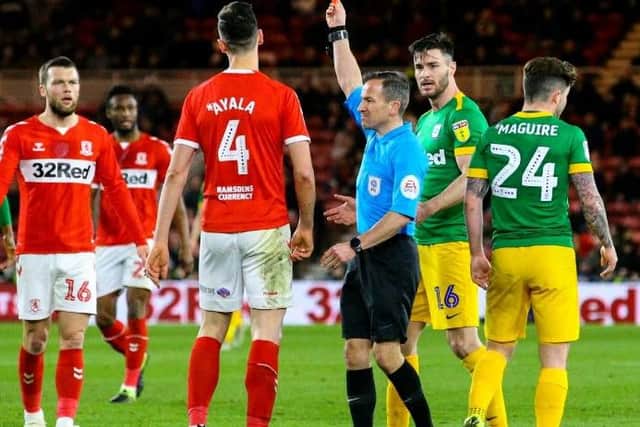 Daniel Ayala is shown the red card by referee Keith Stroud