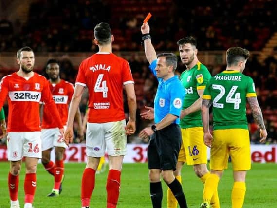 Daniel Ayala is shown the red card by referee Keith Stroud